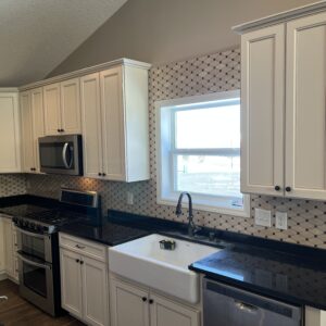 Backsplash installed with a custom look around the window.