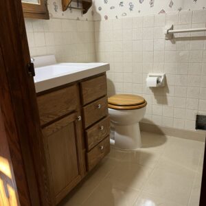 Taller vanity and Toilet along with finished tile (After)