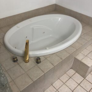 Old tub with tile surround. (Before)